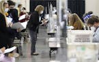 Recount observers watch ballots during a Milwaukee hand recount of Presidential votes at the Wisconsin Center, Friday, Nov. 20, 2020, in Milwaukee, Wi
