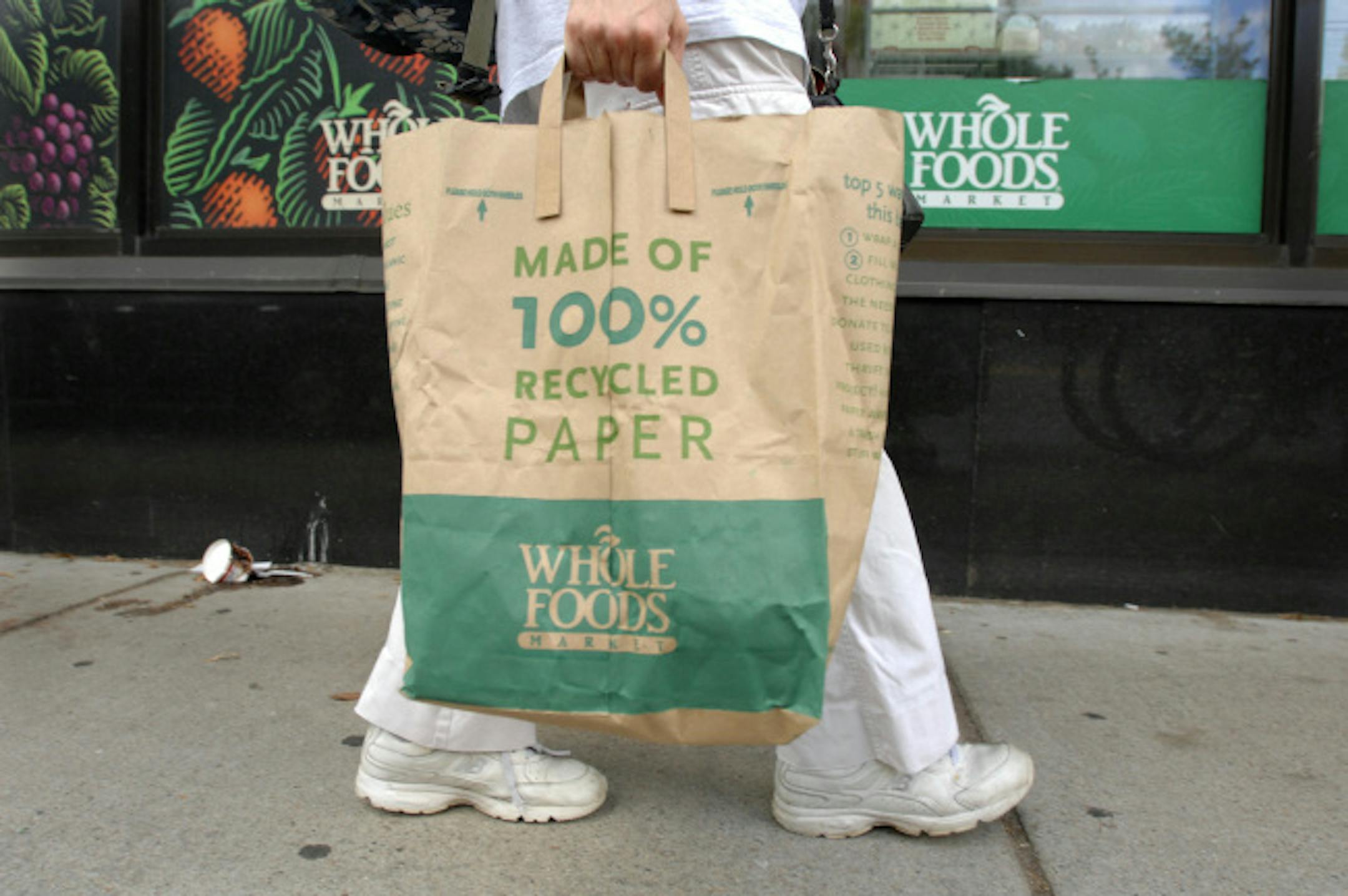 A customer walks home from the Whole Foods Market in Cambridge, Mass., Saturday, Aug. 9, 2008. Whole Foods Market is recalling fresh ground beef sold between June 2 through Aug. 6 after reports that customers in Massachusetts and Pennsylvania were sickened. Some of Whole Foods beef is supplied by Nebraska Beef Ltd, which is recalling 1.2 million pounds of beef because the products may be contaminated with E. coli bacteria.