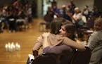 At the end of the program, organizer Sarah Super, left, was hugged by Kaitlyn, one of a dozen women who shared their experiences at the "Break the Sil