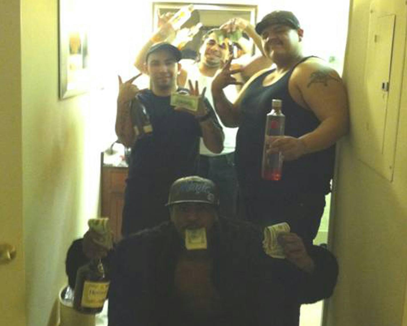 Heroin distributor Deangelo Curtis, AKA &#x201a;&#xc4;&#xfa;King Kong,&#x201a;&#xc4;&#xf9; lower front, celebrating his heroin profits with his drug suppliers at the Homewood Hilton Suites in Bloomington, early 2012. All are members of the Latin Kings gang and were convicted in federal court. Clockwise, Curtis, bottom; Cabanas, left; Enrique Enriquez; Camilo, AKA &#x201a;&#xc4;&#xfa;Heavy,&#x201a;&#xc4;&#xf9; Alvarez. Photo was taken from Cabanas&#x201a;&#xc4;&#xf4; cell phone.