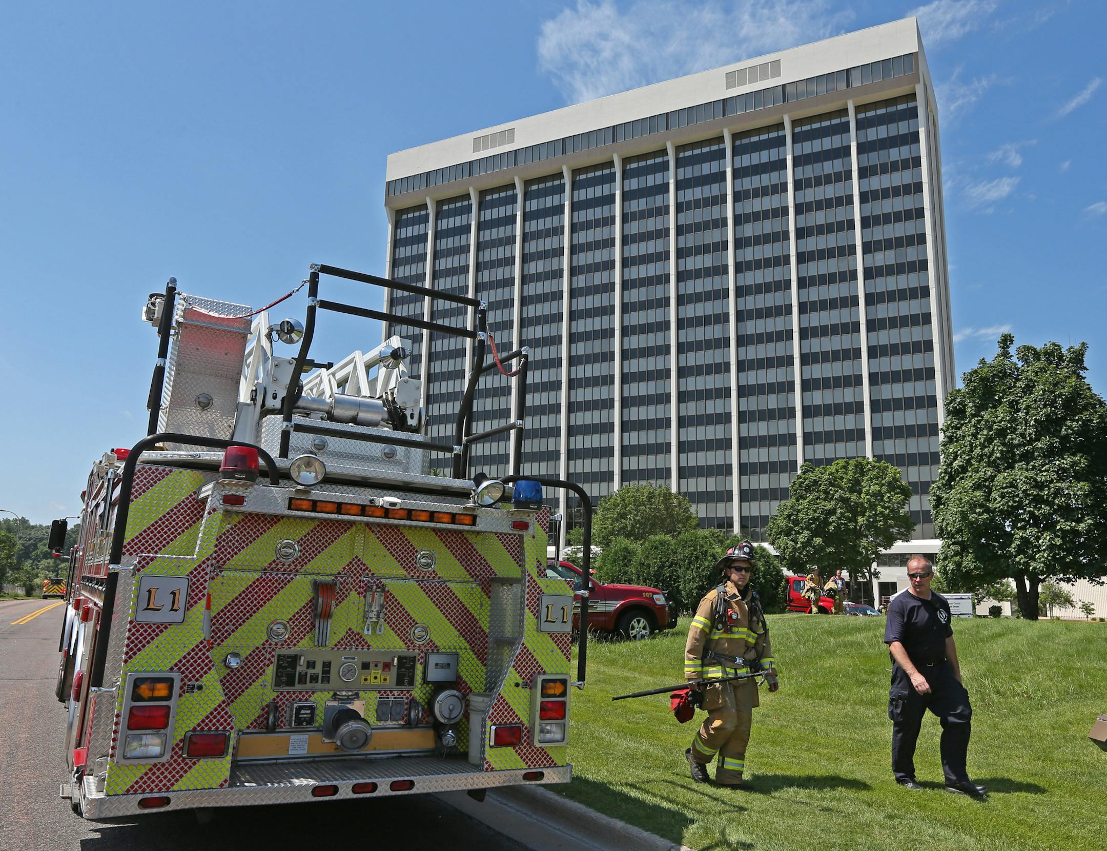 Firefighters left the the 600 office building at Hwy 169 and Hwy 394, as muiltiple units responded to a transformer fire in the parking garage next to the building on 7/18/13.} Bruce Bisping/startribune bbisping@startribune.com