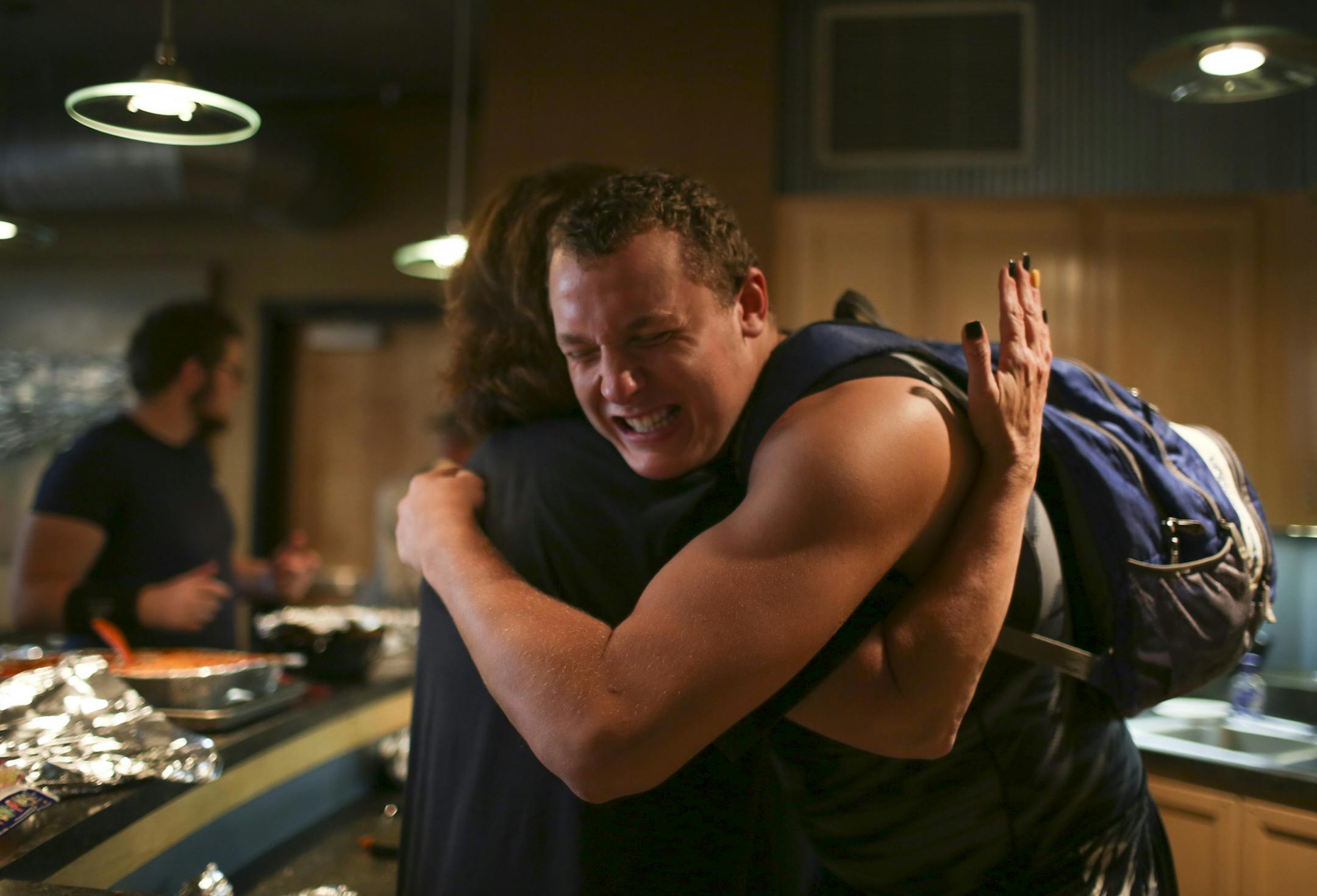 DeLaSalle lineman Drayton Carlberg hugged his mom, Natalie, after the team meal in the community room of his family's North Loop home Thursday evening. He was leaving to take in a volleyball game. ] JEFF WHEELER ‚Ä¢ jeff.wheeler@startribune.com DeLaSalle lineman Drayton Carlberg is one of Minnesota's most highly recruited seniors. His family hosted a team meal at their North Loop building after the Islanders walk through practice Thursday afternoon, September 5, 2014.
