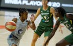 Lynx guard Crystal Dangerfield drives against Seattle guard Sue Bird (10) and forward Natasha Howard (6) during the first half of Game 2