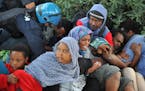 Italian Police remove migrants in Ventimiglia, at the Italian-French border Tuesday, June 16, 2015. Police at Italy's Mediterranean border with France