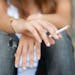 iStockphoto.com Teenage hands holding cigarette outdoor.
