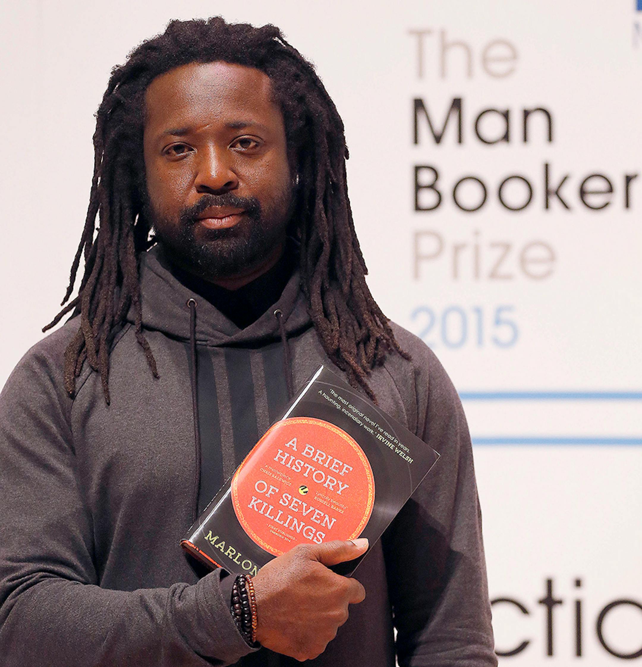 Author Marlon James poses with his book 'A Brief History of Seven Killings' on stage at the Royal Festival Hall in London, Monday, Oct. 12, 2015. James is one of six short-listed authors of the 2015 Man Booker Prize for Fiction. The winner will be announced Tuesday Oct. 13.