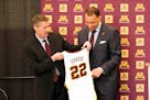 New University of Minnesota mens' head basketball coach Ben Johnson, right, receives his own number from athletic director Mark Coyle following a pres