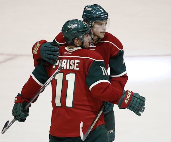 Minnesota Wild center Charlie Coyle (3) and left wing Zach Parise (11).