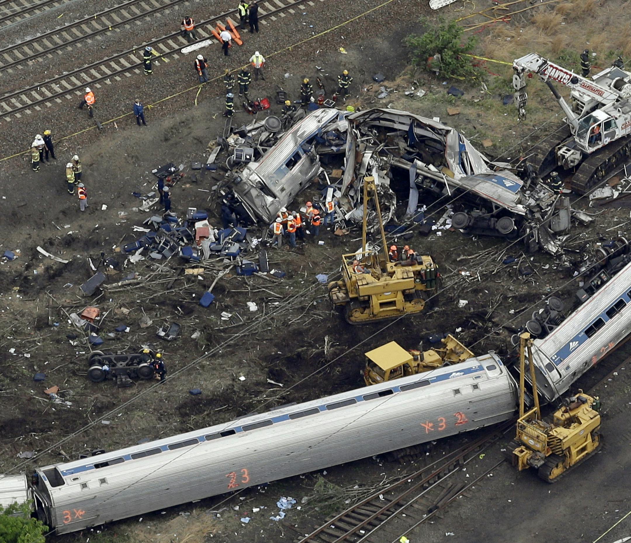FILE ñ In this May 13, 2015, file photo, emergency personnel work near the wreckage of a New York City-bound Amtrak passenger train following a derailment that killed eight people and injured about 200 others in Philadelphia. The state's attorney general has a wide range of options in responding to a judge's order to arrest a speeding Amtrak engineer involved in the deadly 2015 crash, a law professor said Friday, May 12, 2017. (AP Photo/Patrick Semansky, File)