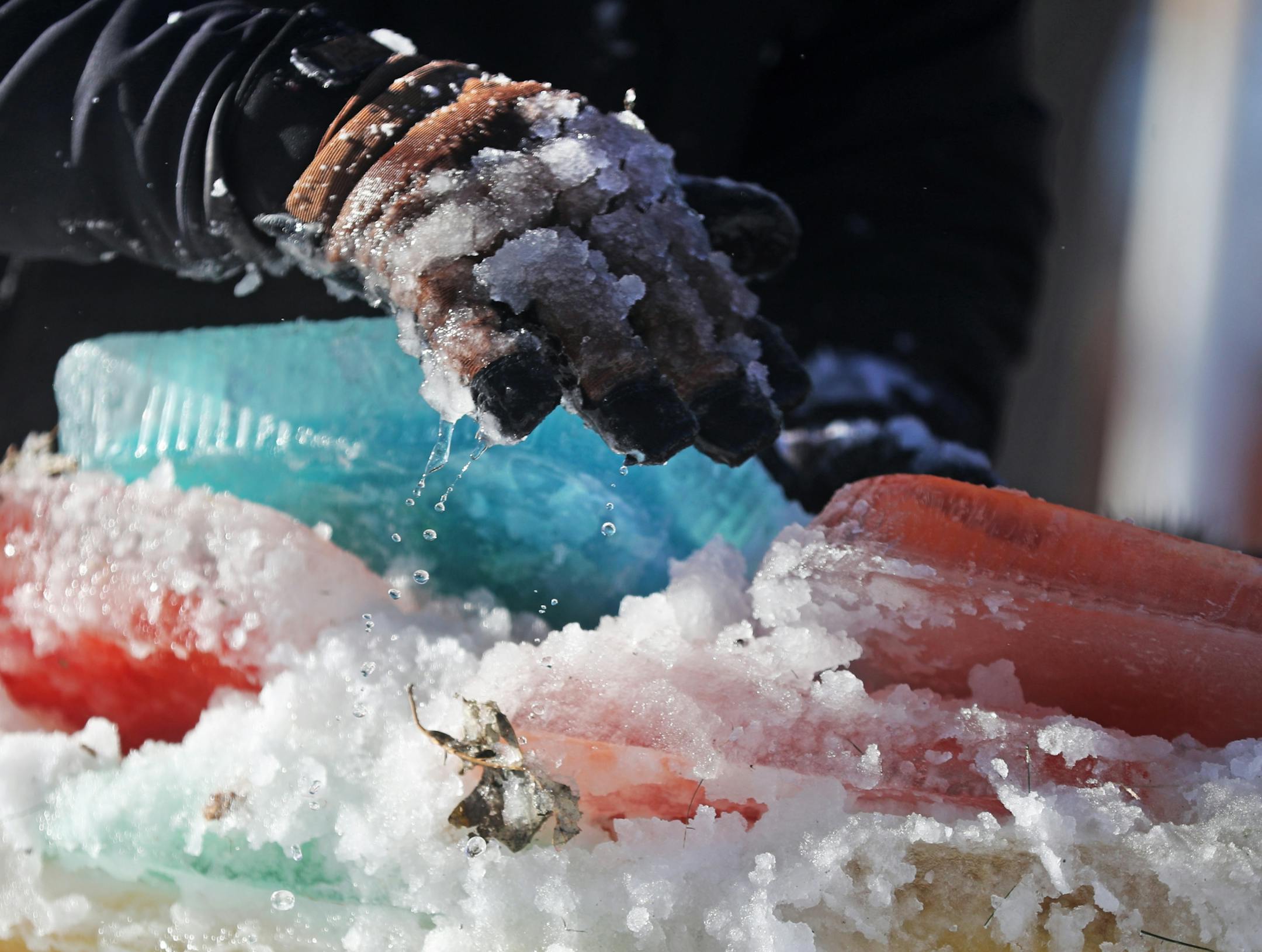 Martha Palm, her family and some former students of hers will be working on the multi-colored igloo they are building at the Palms' south Minneapolis home and seen Saturday, Dec. 30, 2017, in Minneapolis, MN. Here, a mixture of snow and water was mixed together to form the mortar to bond the ice blocks together.