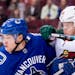 Wild right winger Mikael Granlund jostled for control of the puck with Canucks defenseman Derrick Pouliot in the first period of Vancouver's 5-2 victo