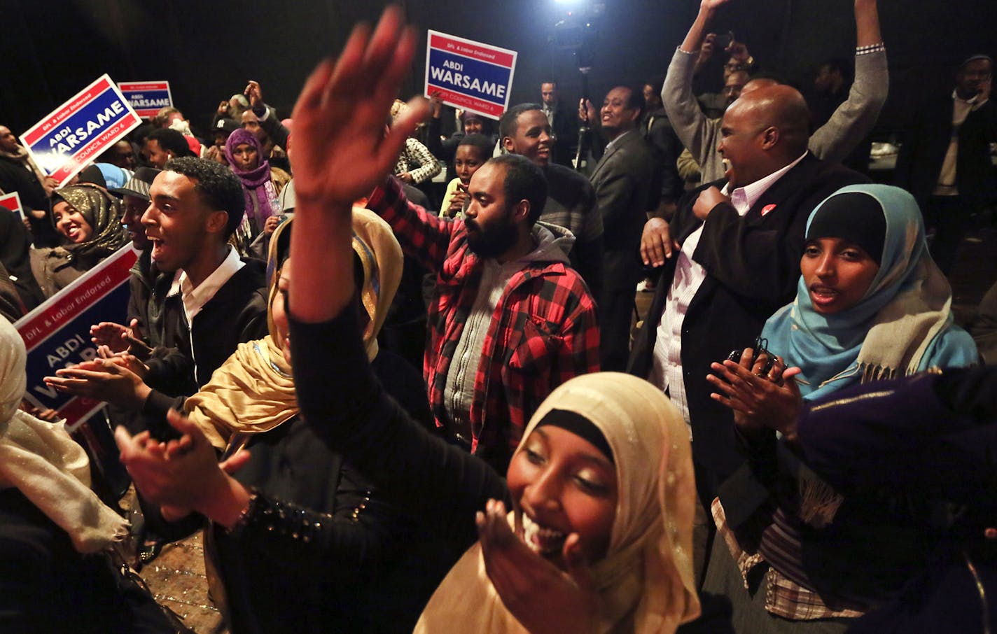 Ward 6 city council candidate Abdi Warsame's supporters erupt in celebration after it is announced tht Warsame had unofficially won the race at the Mixed Blood Theatre, where the campaign gathered for the election results and a celebration Tuesday, Nov. 5, 2013, in Minneapolis, MN. Warsame won in a landslide, garnering 64 percent of the vote and becoming the highest elected Somali-American in the country.](DAVID JOLES/STARTRIBUNE) djoles@startribune.com Minneapolis City Council race: Should know