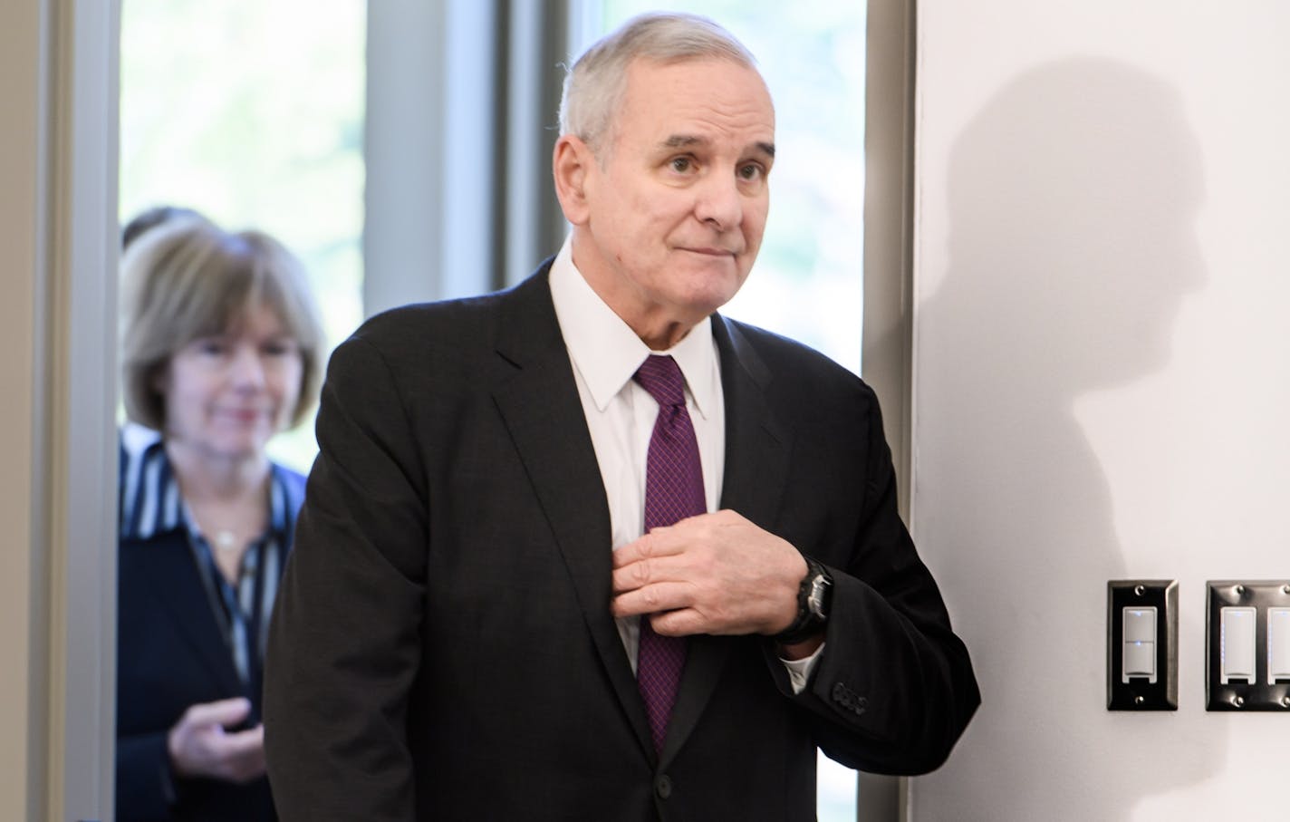 Gov. Mark Dayton reached for his notes as he entered the press conference.