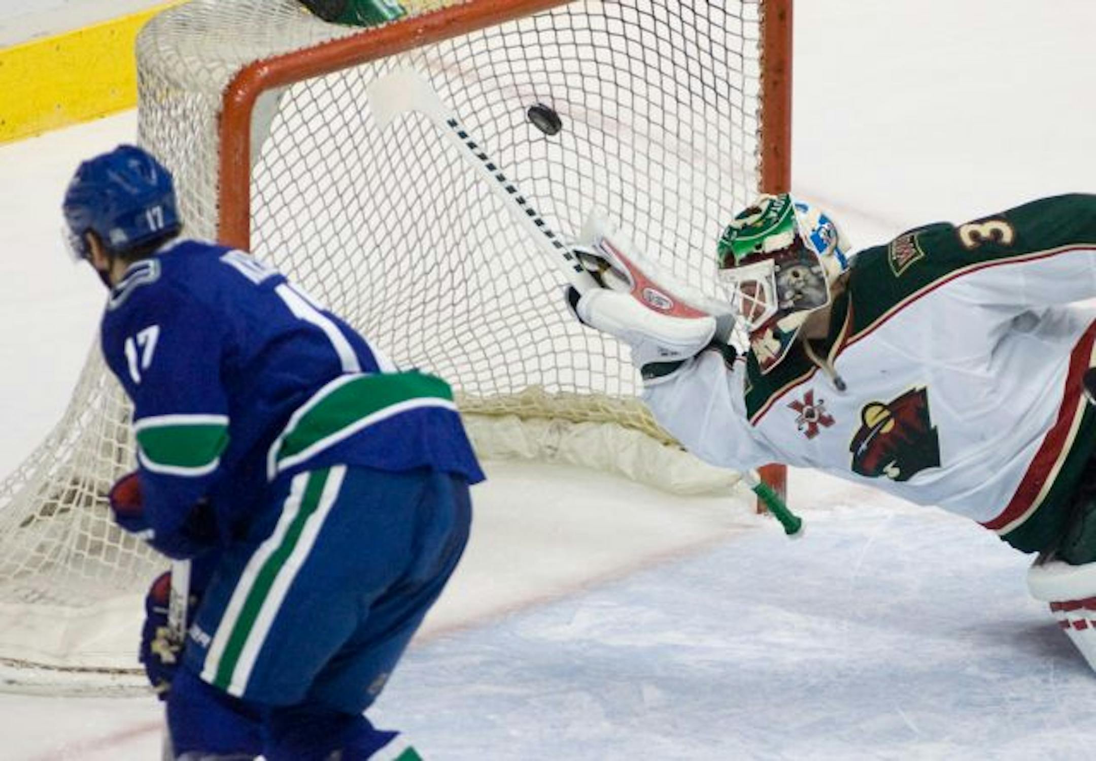 Canucks center Ryan Kesler (17) sent the puck past Wild goalie Niklas Backstrom during the first period Monday.