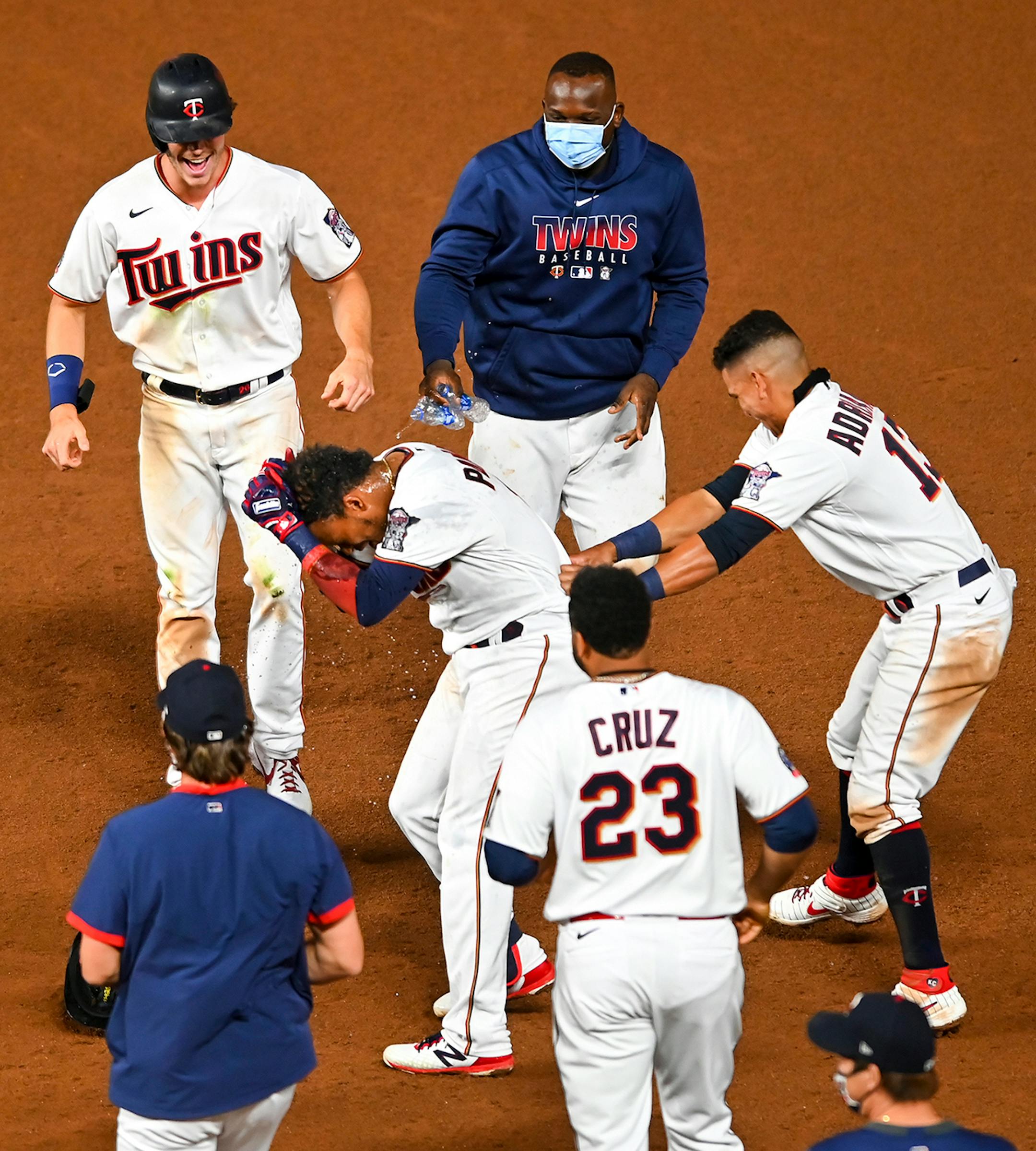 Teammates celebrated a walk-off RBI hit by Minnesota Twins shortstop Jorge Polanco (11) in the bottom of the 12th inning against the Milwaukee Brewers.