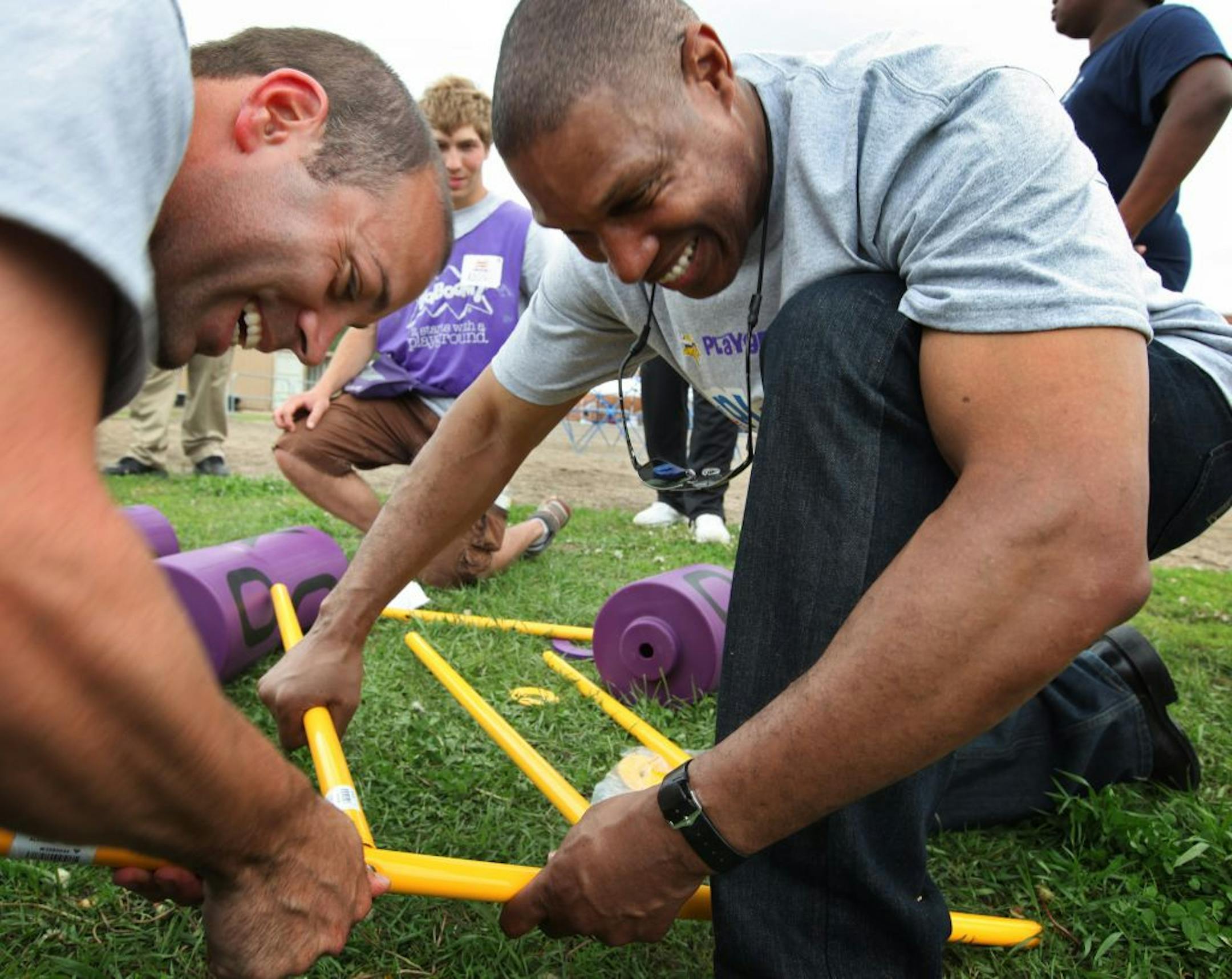 More than 250 volunteers, including more than 100 Vikings staff, coaches and former players, Toro employees and organizers from KaBOOM!—a national nonprofit organization that envisions a great place to play within walking distance of every child in America-will joined forces to build a new and safe playground at Northport Elementary School in Brooklyn Center Friday. (IN THIS PHOTO) Vikings coach Leslie Frazier (right) helps North Port Elementary School Principal Patrick Smith assemble a tic-tac-