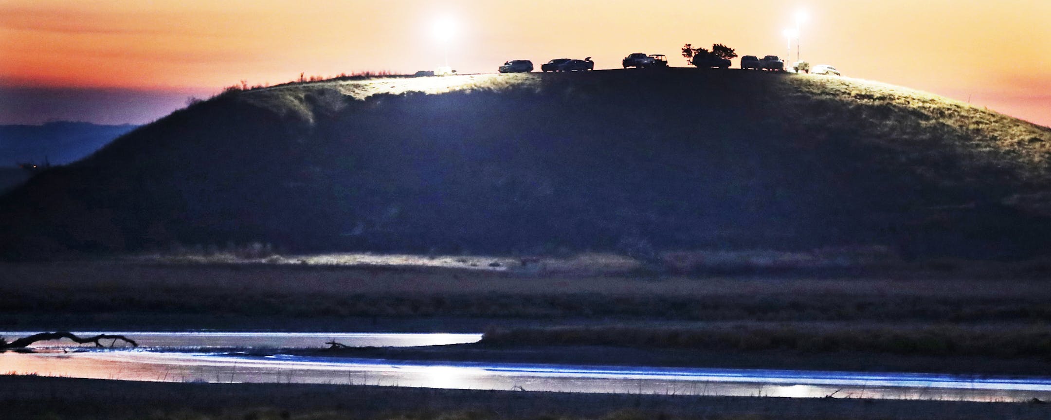 On a nearby hillside, authorities surveyed and protected the Dakota Access oil pipeline&#x2019;s domain in North Dakota near the Standing Rock Reservation, site of ongoing protests.