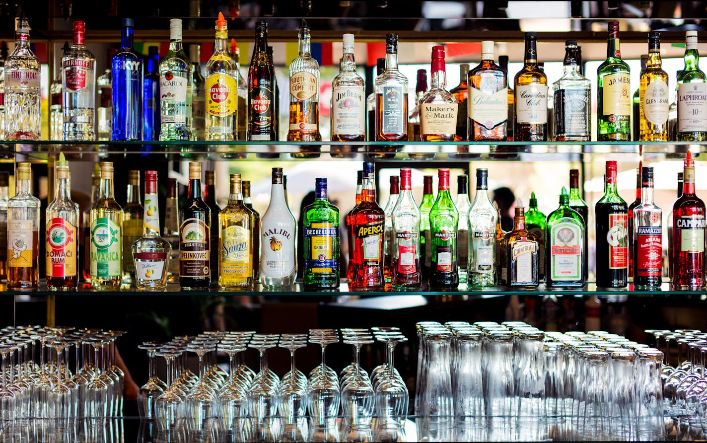 various liquor bottles at a bar. istock