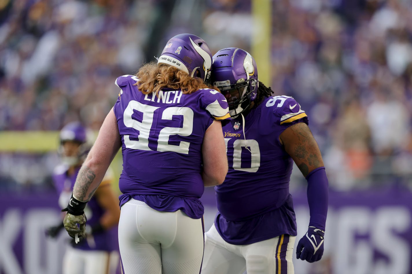 Minnesota Vikings defensive tackles Sheldon Richardson (90) and James Lynch (92) celebrate after a play during the second half of an NFL football game against the Green Bay Packers, Sunday, Nov. 21, 2021 in Minneapolis. Minnesota won 34-31. (AP Photo/Stacy Bengs)