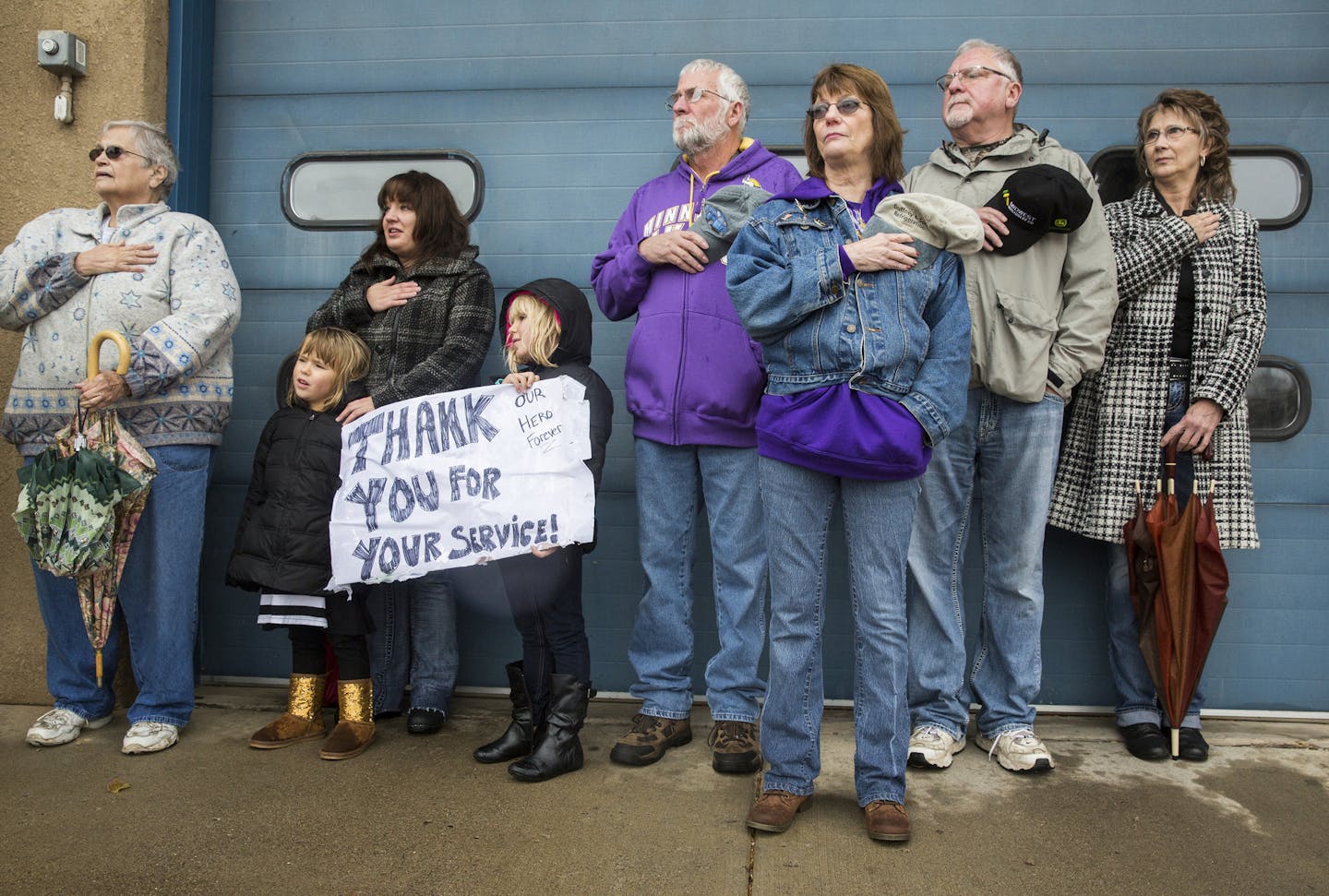 Mourners line the funeral procession route on Highway 169 in downtown Aitkin. ] (LEILA NAVIDI/STAR TRIBUNE) leila.navidi@startribune.com BACKGROUND INFORMATION: The funeral service and procession for Aitkin County Sheriff&#xed;s Deputy Steven Sandberg in Aitkin, Minn. on Friday, October 23, 2015.