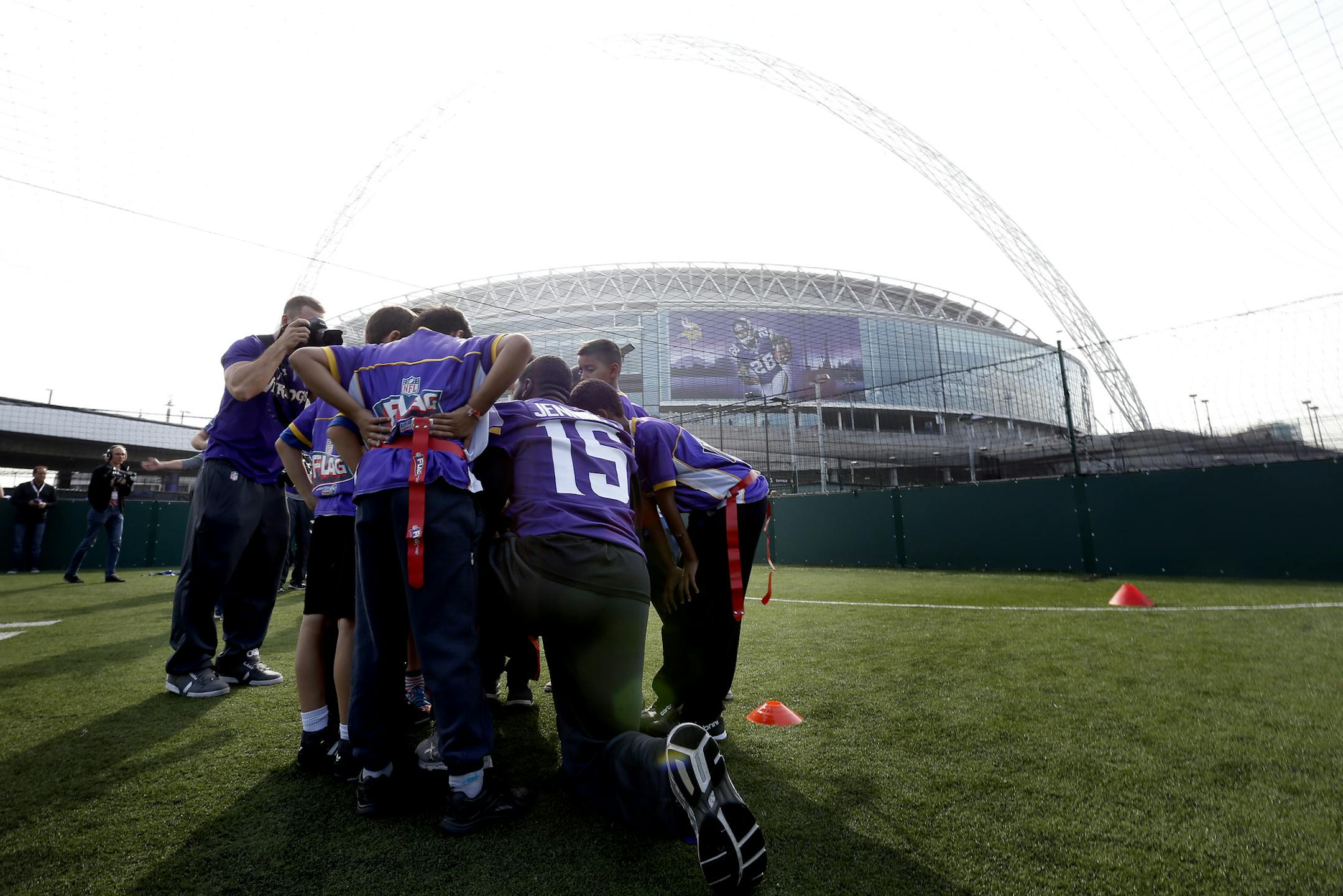 Minnesota Vikings receiver Greg Jennings (15) huddled up with children participating at Tuesday's event outside of Wembley Stadium shortly after the team arrived in London for Sunday's game vs. the Pittsburgh Steelers. ] CARLOS GONZALEZ cgonzalez@startribune.com September 24, 2013, London, England, UK, Wembley Stadium, ,NFL, Minnesota Vikings Community Day ‚Äì Wembley Stadium Vikings,