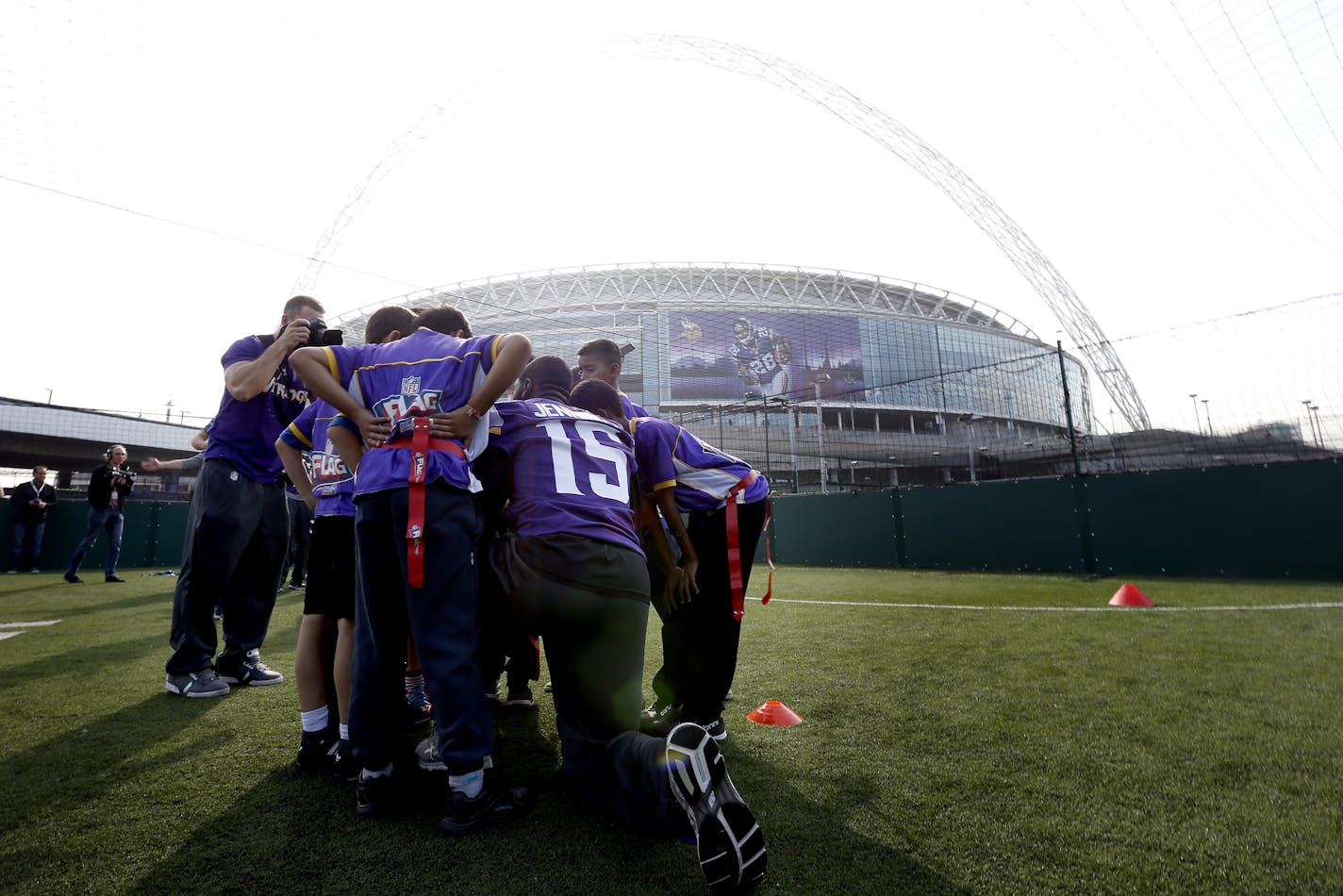 Minnesota Vikings receiver Greg Jennings (15) huddled up with children participating at Tuesday's event outside of Wembley Stadium shortly after the team arrived in London for Sunday's game vs. the Pittsburgh Steelers. ] CARLOS GONZALEZ cgonzalez@startribune.com September 24, 2013, London, England, UK, Wembley Stadium, ,NFL, Minnesota Vikings Community Day &#x201a;&#xc4;&#xec; Wembley Stadium Vikings,