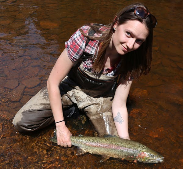 Jade Thomason of Duluth, shown with a North Shore steelhead, is an organizer of this weekend's Great Waters Fly Fishing Expo presented by Trout Unlimi
