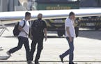 Joesley Batista, former chairman of JBS meatpacking giant, right, arrives at the airport during his transfer to a federal police jail after he turned 