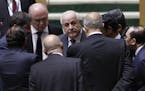 Palestinian Ambassador to the United Nations Riyad Mansour, center, talks with members of the General Assembly prior to a vote, Thursday, Dec. 21, 201