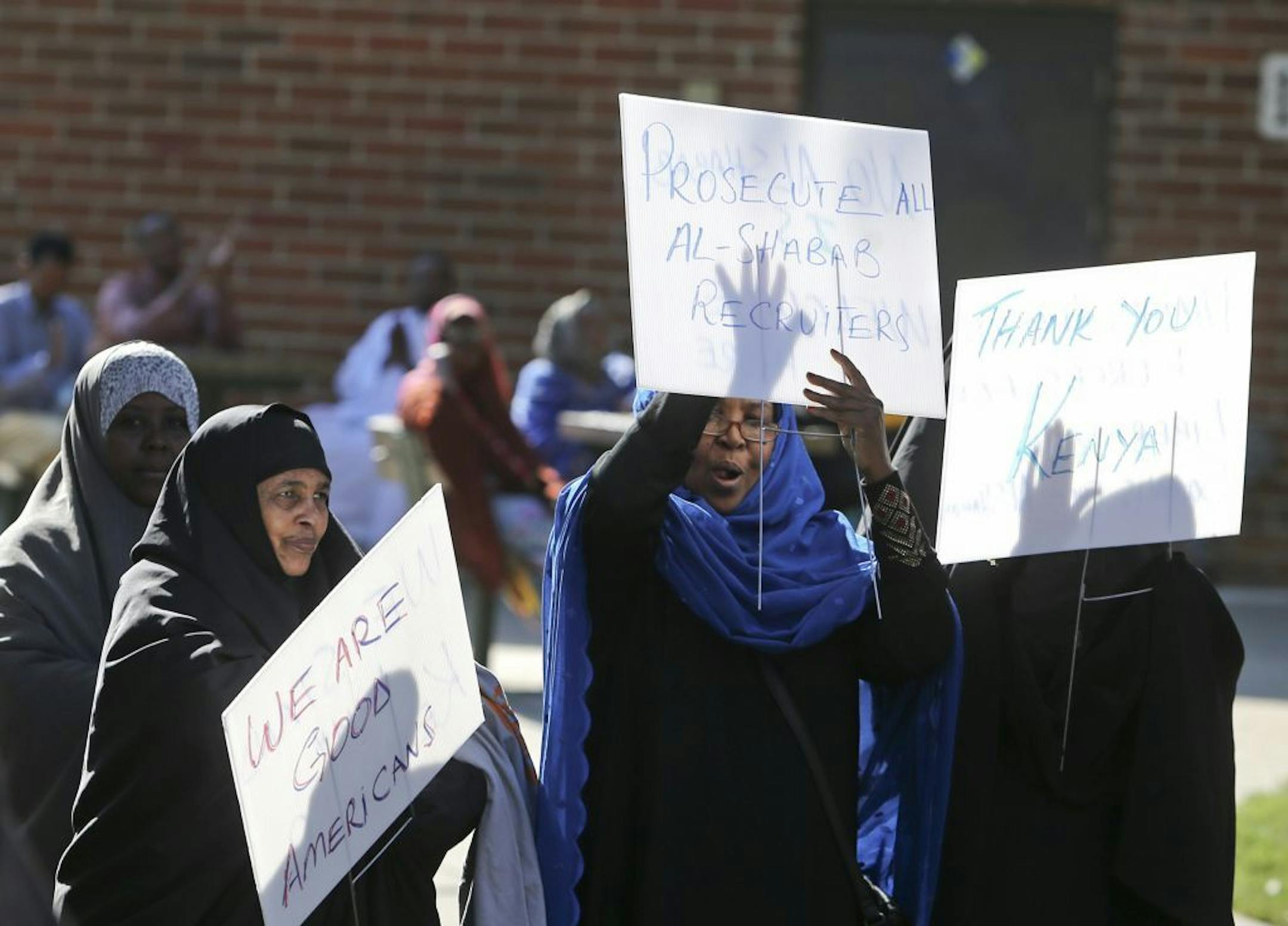 Somali American women, some holding signs, cheered as one of the speakers told the audience that Islam was not about violence but about peace during a rally Friday, Sept. 27, 2013, outside the Brian Coyle Community Center in Minneapolis, MN, in the largely Somali American neighborhood. The rally was held to condemn Al-Shabab's attack on Westgate shopping mall in Nairobi, Kenya recently.
