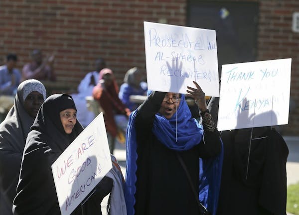 Somali American women, some holding signs, cheered as one of the speakers told the audience that Islam was not about violence but about peace during a
