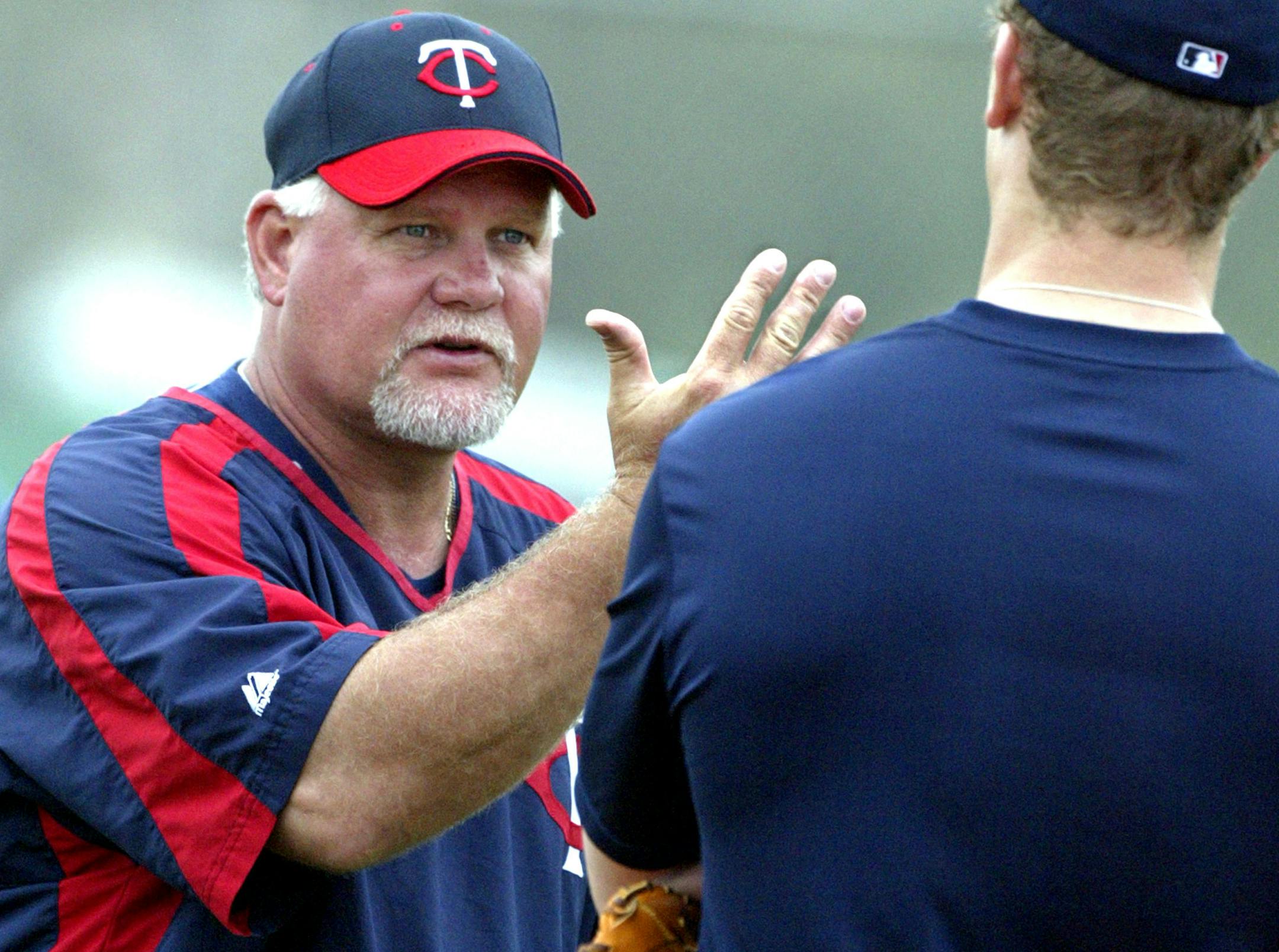 Ron Gardenhire has a teaching moment with first baseman Justin Morneau during spring training in 2006.