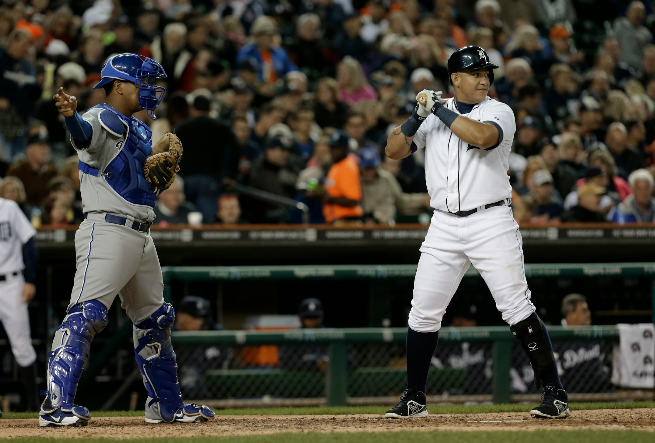 Kansas City Royals catcher Salvador Perez (13) signals an intentional walk for Detroit Tigers' Miguel Cabrera in the fifth inning of a baseball game in Detroit, Friday, Sept. 13, 2013. (AP Photo/Paul Sancya)