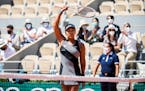 Naomi Osaka acknowledges the crowd following her win against Patricia Maria Tig in the first round of the French Open at Court Philippe Chatrier in Pa