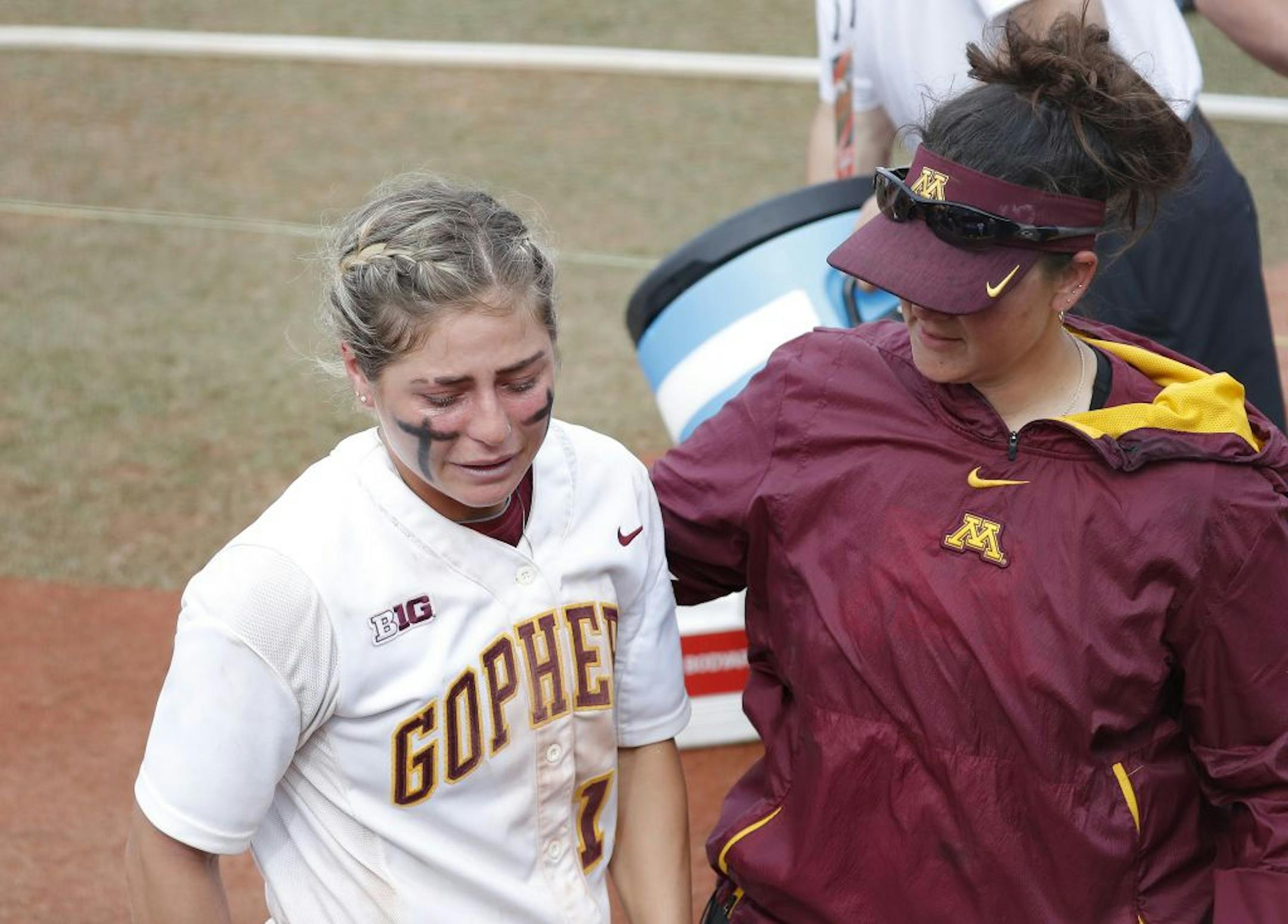 Minnesota's Allie Allie Arneson, left, is emotional following the loss to Washington during the Women's College World Series at ASA Hall of Fame Stadium in Oklahoma City on Saturday, June 1, 2019. Washington won 5-3. Photo by: Alonzo J. Adams