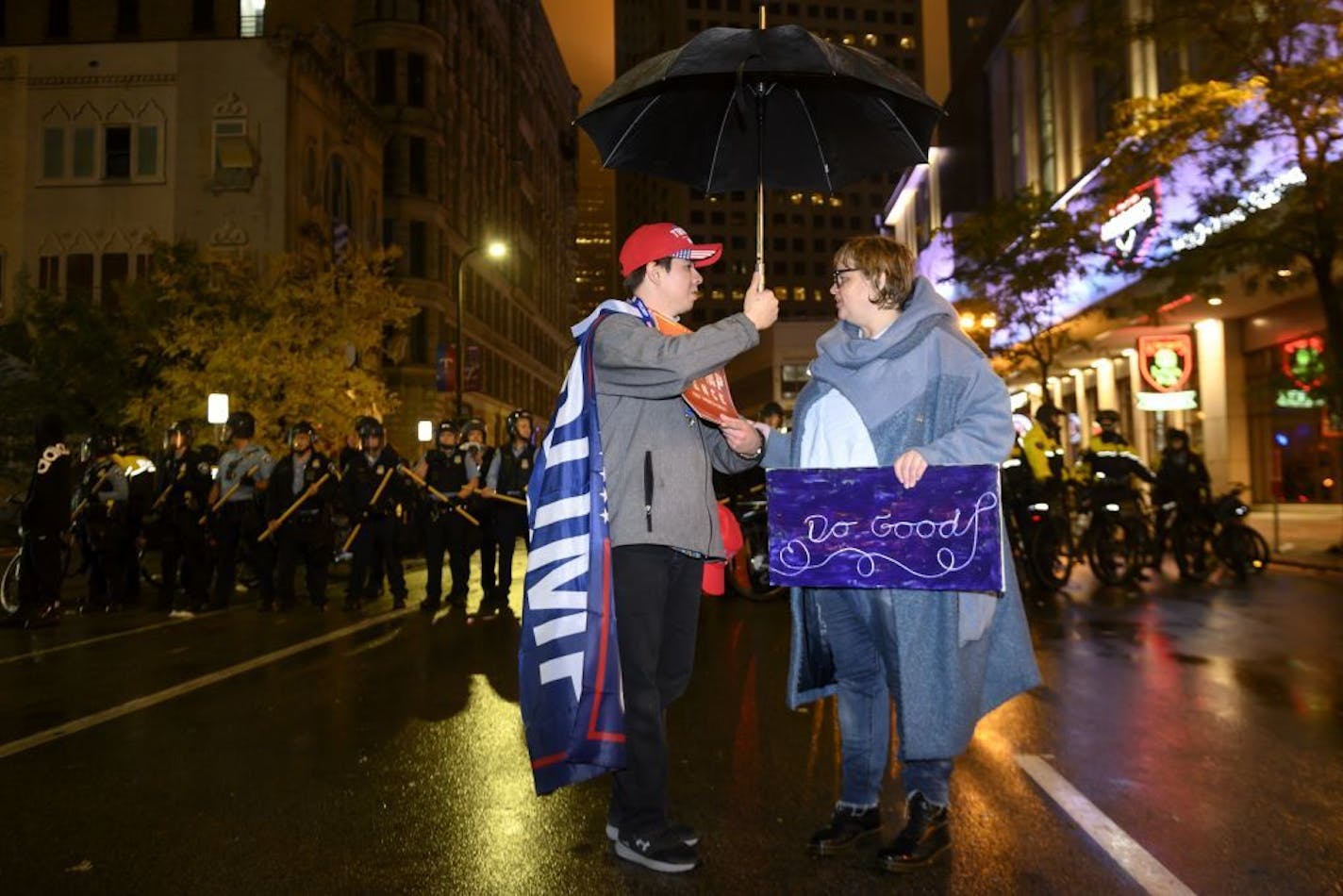 Trump supporter Chris Windego, of International Falls, and Jennifer Fairchild, of Minneapolis, had a civil conversation as Windego shared his umbrella with Fairchild. "I just feel that the Trump people have the right to play safe here." said Fairchild, who more than once put her self between pro and anti-Trump protesters. "We all love this country and I believe that's why we're all here."