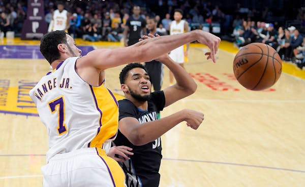 Lakers forward Larry Nance Jr., left, and Timberwolves center Karl-Anthony Towns went after a rebound during the first half Sunday.