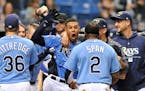 Tampa Bay Rays' Carlos Gomez, center, celebrates with teammates after hitting a two-run walk off home run off Minnesota Twins reliever Addison Reed du
