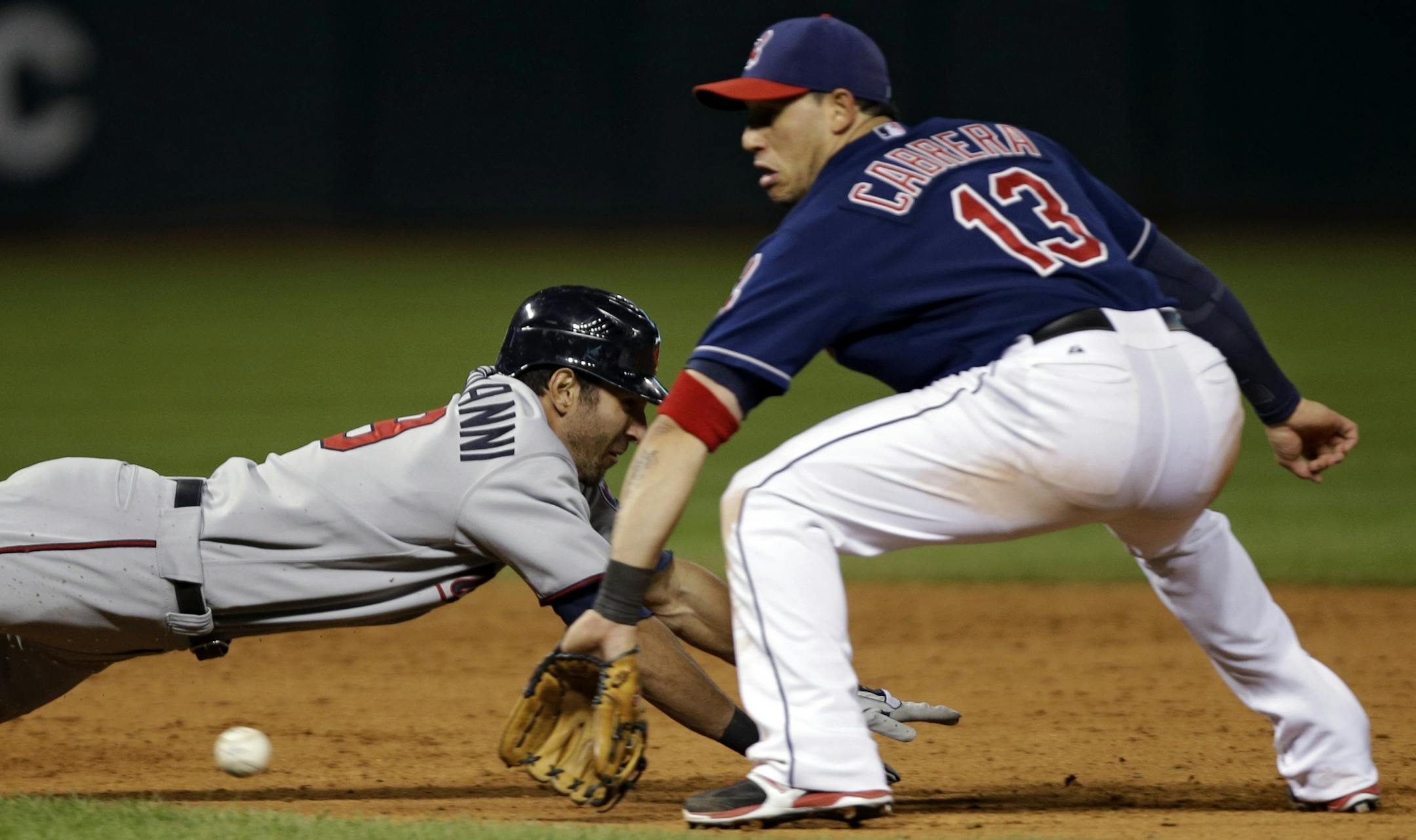 Minnesota's Darin Mastroianni dives back toward second base as Cleveland shortstop Asdrubal Cabrera takes the throw in the eighth inning/