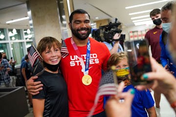 Gable Steveson, gold medal wrestler, takes a photo with fans after arriving at Minneapolis-Saint Paul International Airport on Sunday, August 8, 2021,