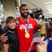 Gable Steveson, gold medal wrestler, takes a photo with fans after arriving at Minneapolis-Saint Paul International Airport on Sunday, August 8, 2021,