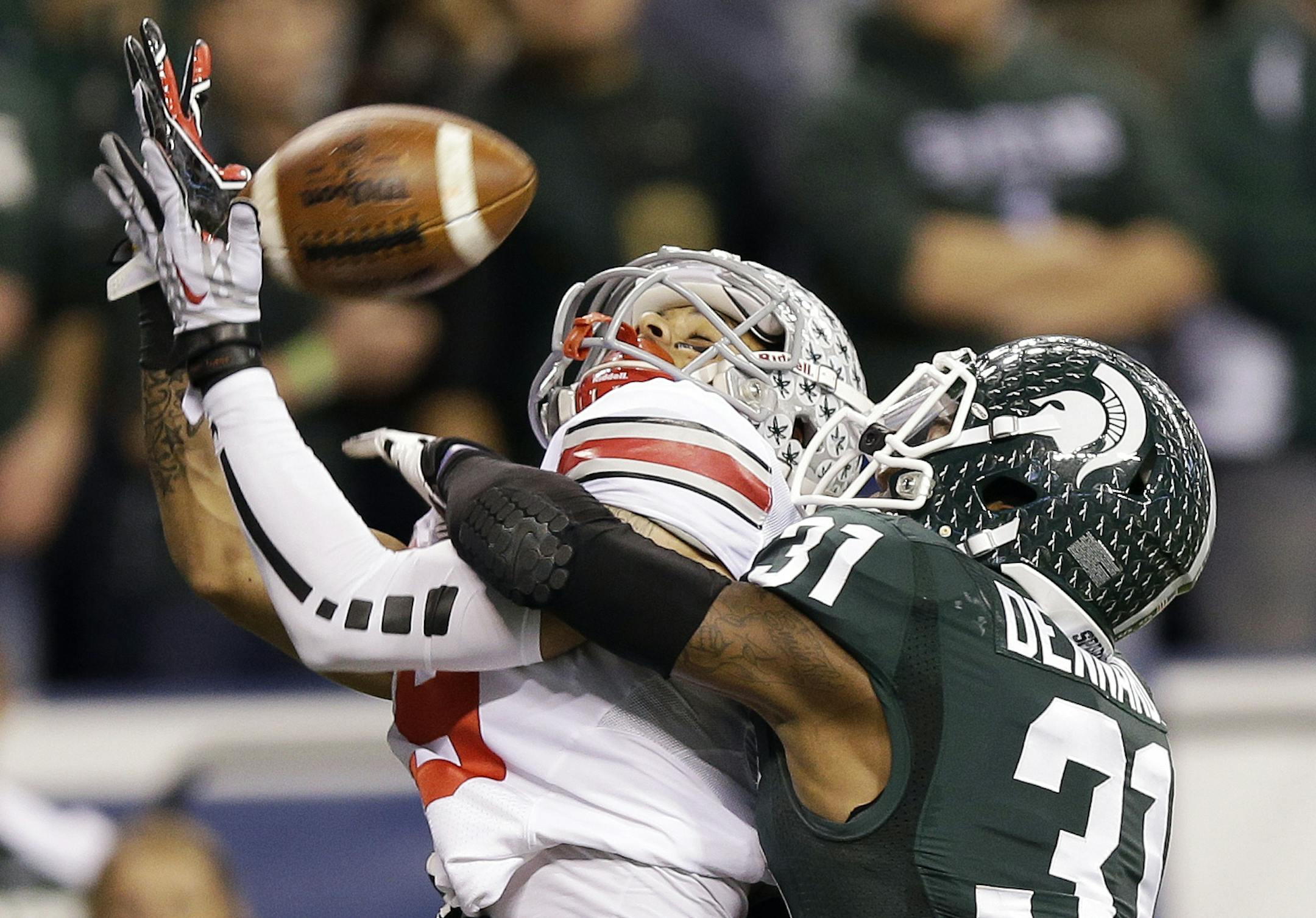 Michigan State's Darqueze Dennard (31) breaks up a pass intended by Ohio State's Devin Smith during the second half of a Big Ten Conference championship NCAA college football game Saturday, Dec. 7, 2013, in Indianapolis. (AP Photo/Michael Conroy)