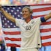 United States' Abby Wambach holds up the U.S. flag as she celebrates after the U.S. beat Japan 5-2 in the FIFA Women's World Cup soccer championship i