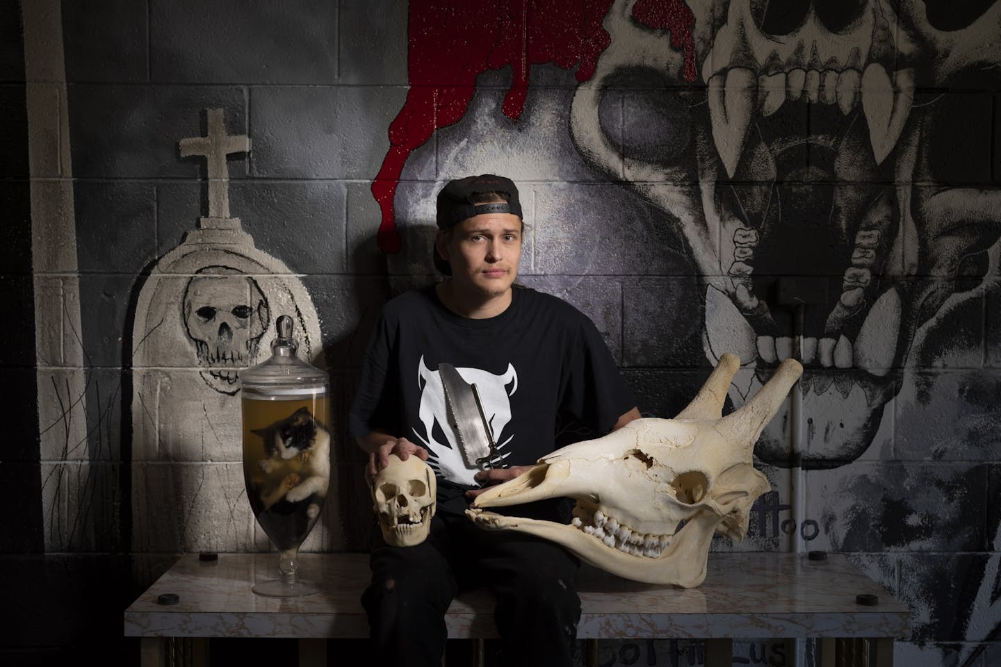 Cameren Torgerud of Studio Payne Art Gallery and Oddities Shop in St. Paul. His store's offerings include a preserved cat (it died of natural causes), a human skull, a bone saw and a giraffe skull.