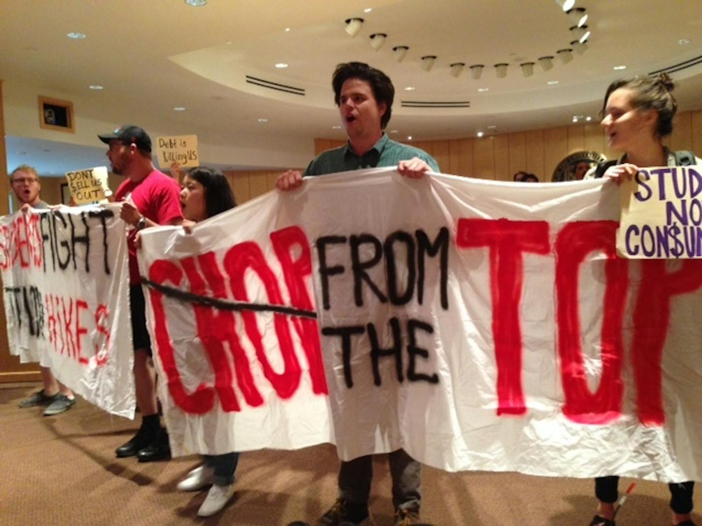 Protesters interrupted a University of Minnesota regents meeting Friday over planned tuition hikes and demanded tuition cuts and the resignation of President Eric Kaler.