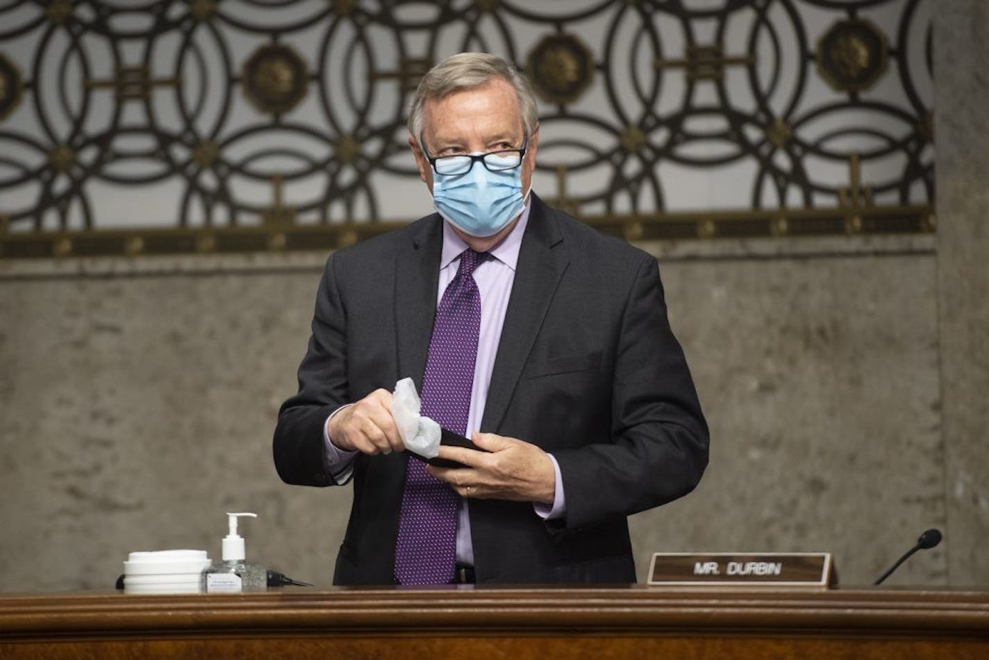 Sen. Richard Durbin, D-Ill., wipes down his phone with a disinfecting wipe before the start of a Senate Judiciary Committee hearing on "Examining Liability During the COVID-19 Pandemic" on Capitol Hill in Washington on Tuesday, May 12, 2020.