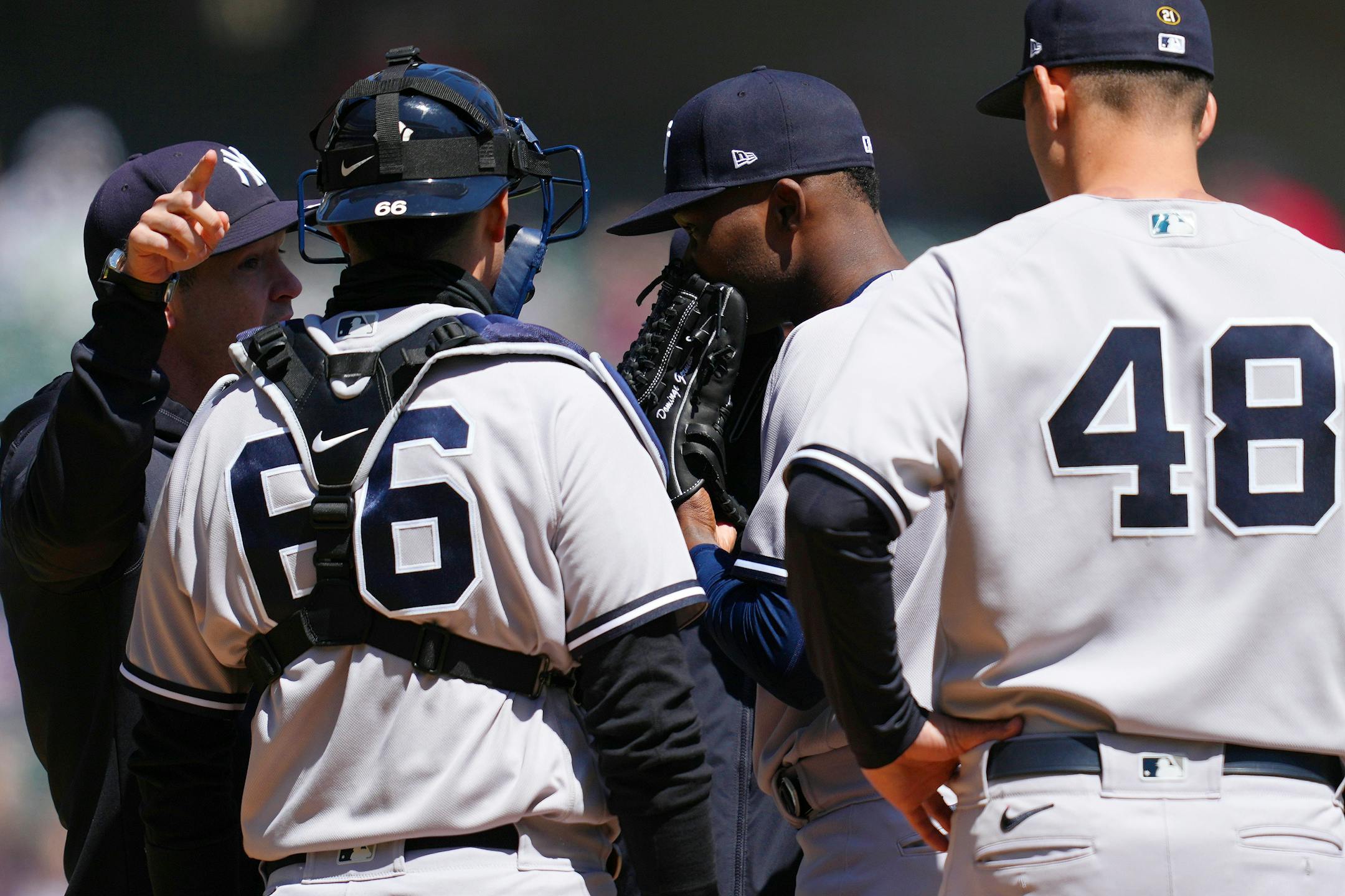 New York Yankees starting pitcher Domingo German (0) gets a visit to the mound in the second inning.