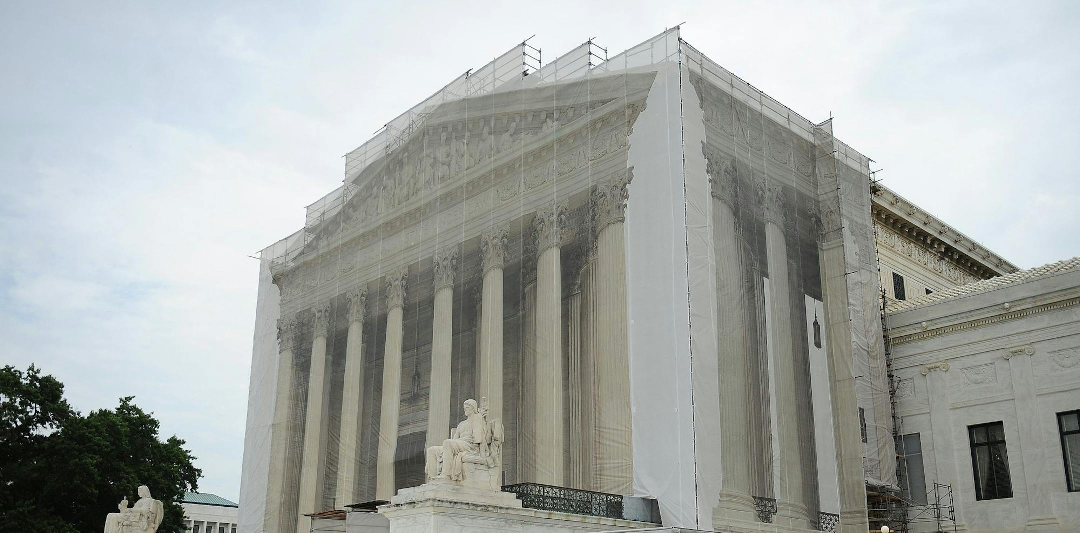 A full-size scrim imprinted with the U.S. Supreme Court building's facade covers scaffolding during renovation work at the Supreme Court in Washington, D.C., on Wednesday, July 10, 2013.