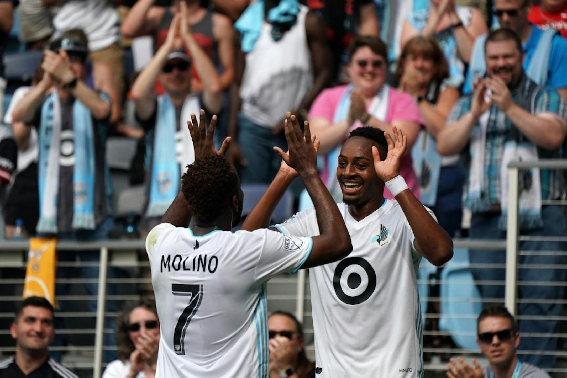 Minnesota United midfielder Kevin Molino (7) congratulated Minnesota United forward Mason Toye (23) after he scored a goal in the second half.