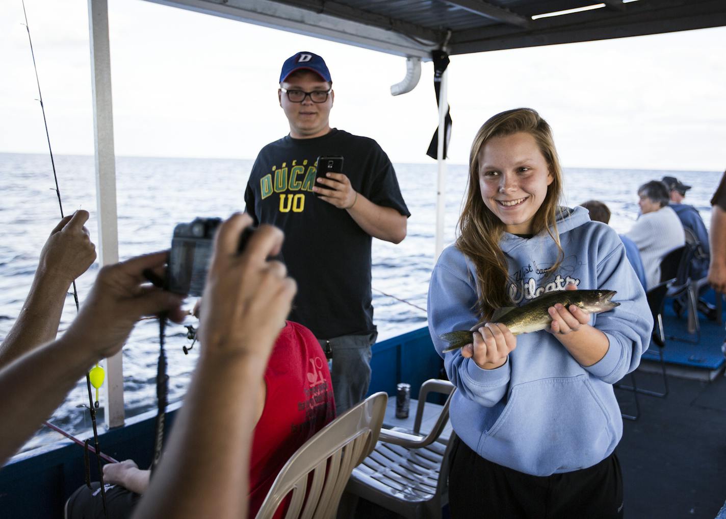 Emily Biondo, 17, of Chicago poses for a photo with a walleye she caught and then released during an exhibition with Twin Pines Resort on Mille Lacs Lake Monday, August 3, 2015. ] LEILA NAVIDI leila.navidi@startribune.com /